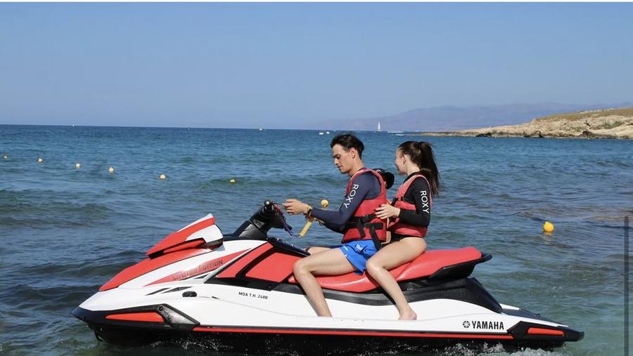 Two riders on a red Yamaha jet ski