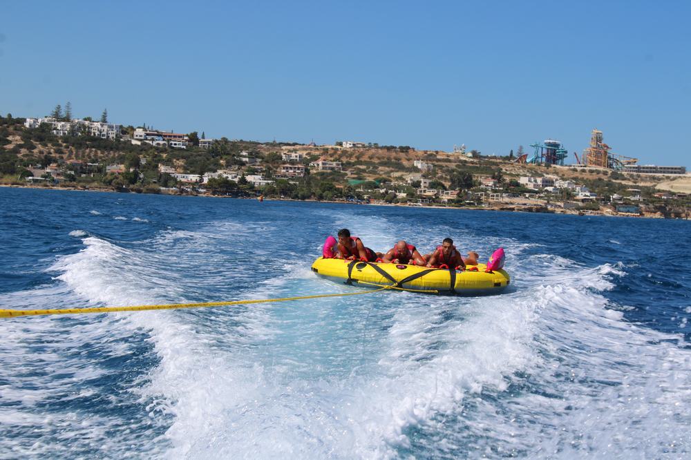 Three riders towed on the inflatable sofa